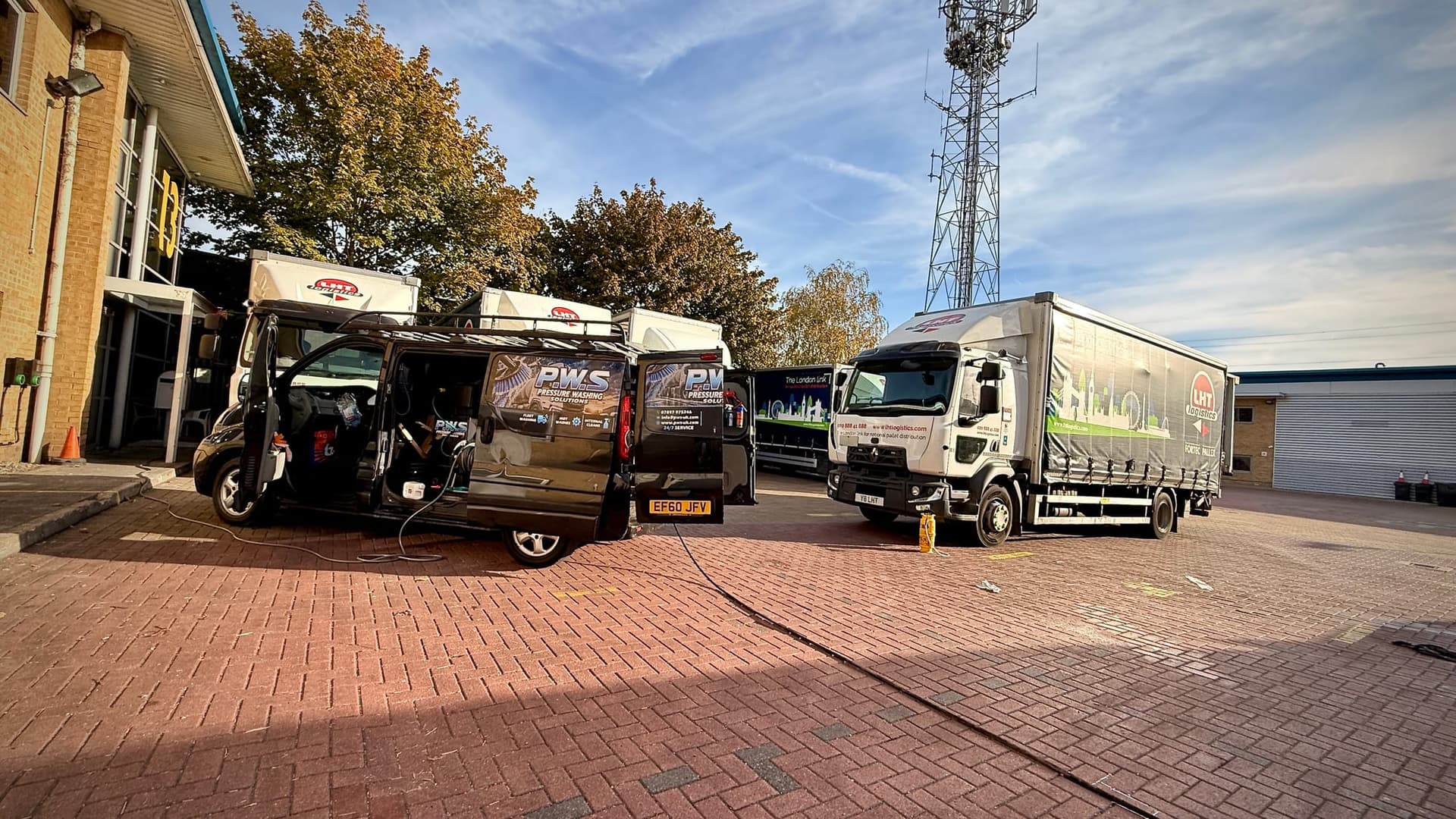 PWS mobile washing van beside a fleet of curtain-sided trailers