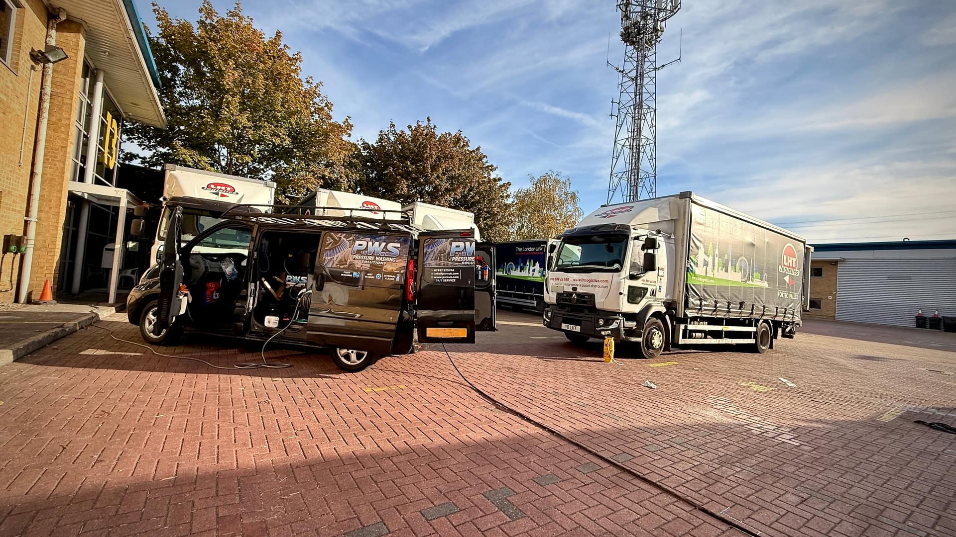 PWS mobile washing van beside commercial vehicles at a fleet washing visit