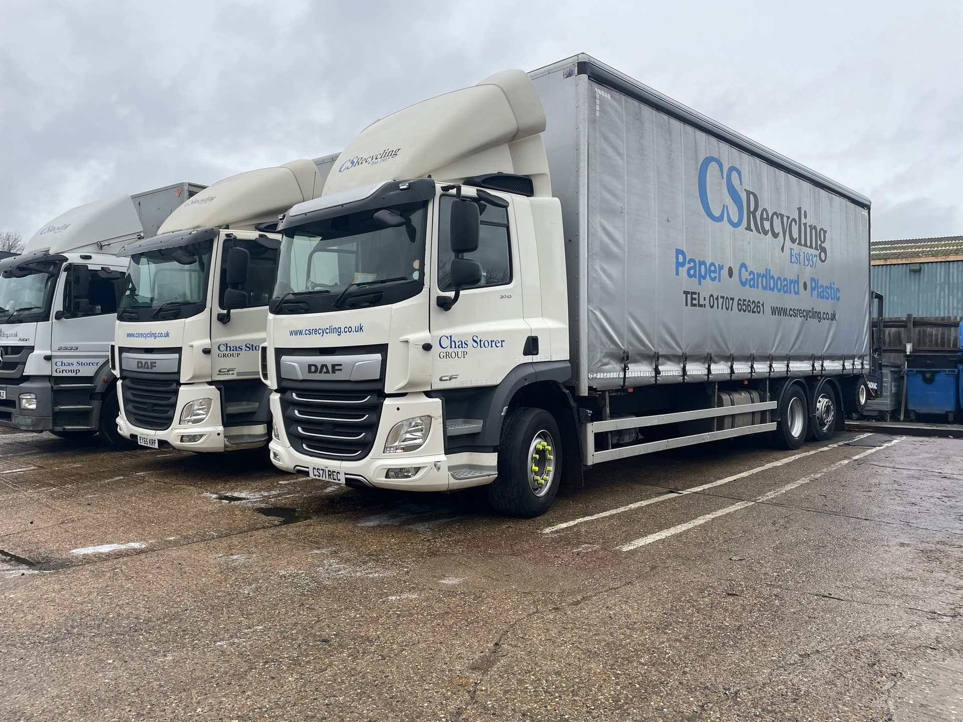 Commercial fleet vehicles lined up for on-site cleaning